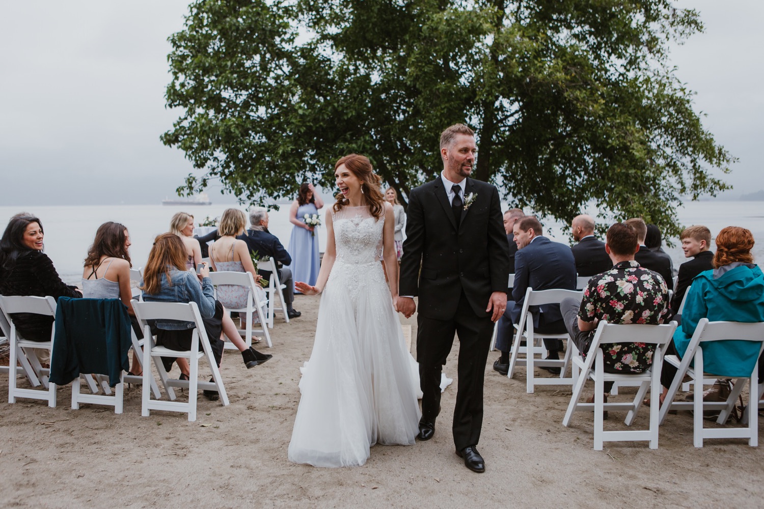 Bride and Groom walking down the aisle after their first kiss